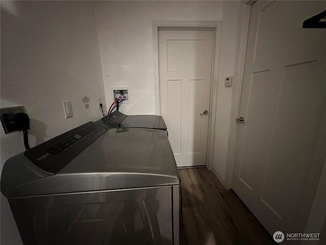 laundry area featuring dark wood-type flooring, laundry area, and separate washer and dryer