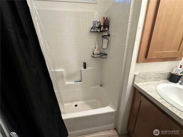 bathroom with shower / bath combo with shower curtain and vanity