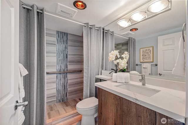 full bathroom featuring toilet, visible vents, and a stall shower