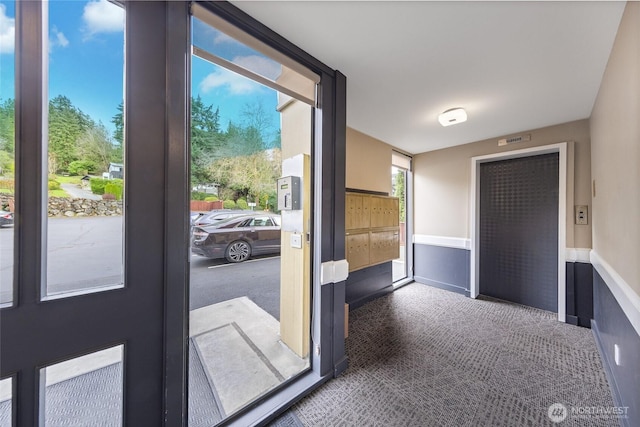 interior space featuring elevator and carpet flooring