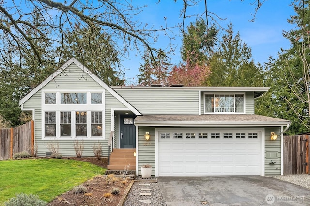 view of front of house with a front lawn, fence, aphalt driveway, roof with shingles, and a garage