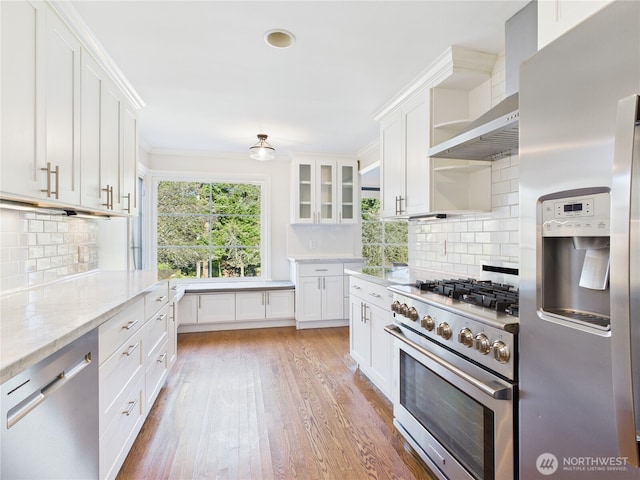 kitchen with light wood-style floors, white cabinetry, appliances with stainless steel finishes, and open shelves