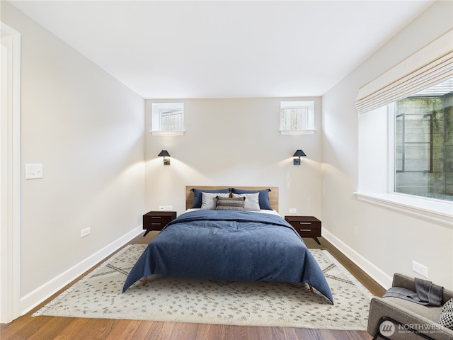 bedroom featuring baseboards and wood finished floors