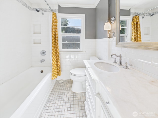 bathroom featuring a healthy amount of sunlight, tile walls, crown molding, and vanity