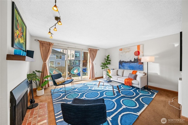 living area with carpet floors, a brick fireplace, baseboards, and a textured ceiling