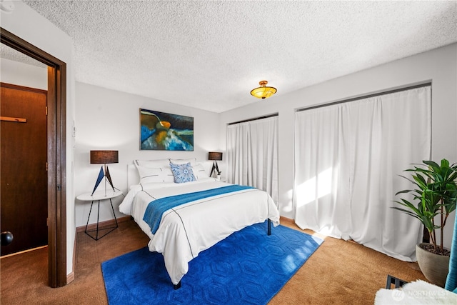 bedroom with carpet floors, a textured ceiling, and baseboards