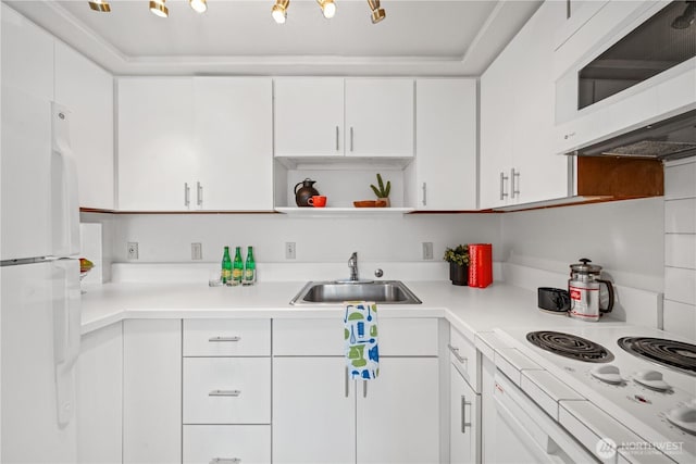 kitchen with white appliances, light countertops, white cabinetry, open shelves, and a sink