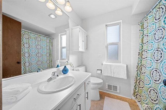 bathroom featuring toilet, a shower with curtain, visible vents, and vanity