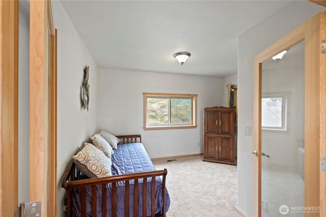 bedroom featuring light colored carpet and baseboards