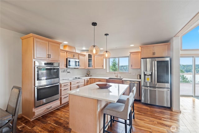 kitchen featuring stainless steel appliances, glass insert cabinets, dark wood-style floors, and light brown cabinetry