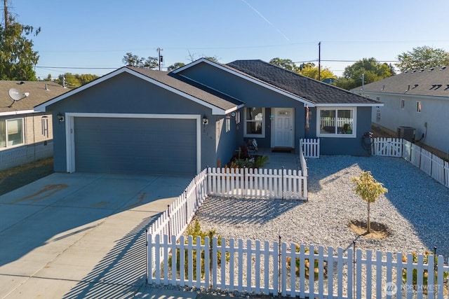 ranch-style house featuring an attached garage, fence private yard, concrete driveway, and stucco siding