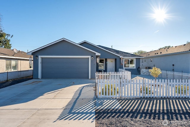 single story home with a fenced front yard, driveway, an attached garage, and stucco siding