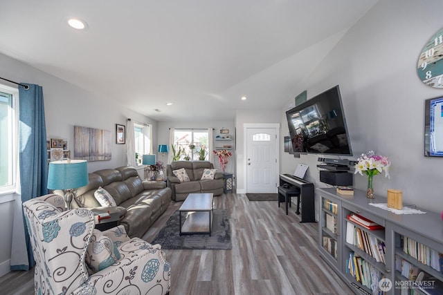 living room with baseboards, vaulted ceiling, wood finished floors, and recessed lighting