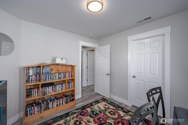 home office featuring visible vents, baseboards, and wood finished floors