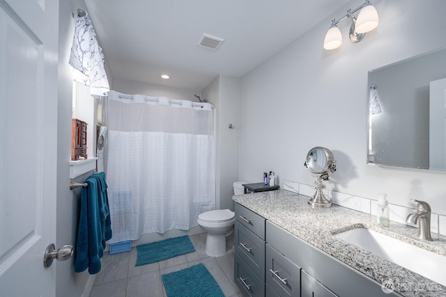 bathroom featuring tile patterned flooring, visible vents, vanity, and toilet