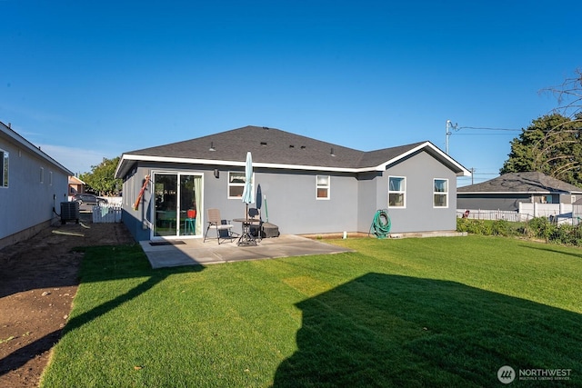 back of property with a patio, central AC, fence, a yard, and stucco siding