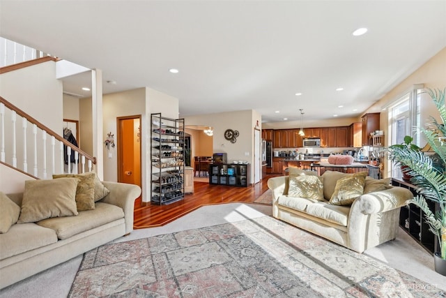 living room with stairway, recessed lighting, and wood finished floors