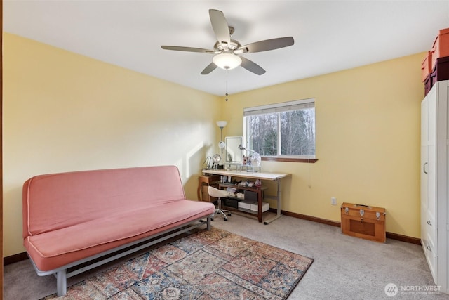 sitting room featuring a ceiling fan, baseboards, and carpet floors