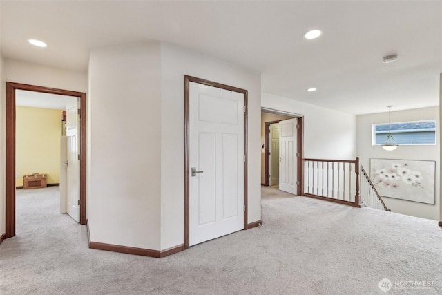 hall featuring recessed lighting, baseboards, an upstairs landing, and carpet floors