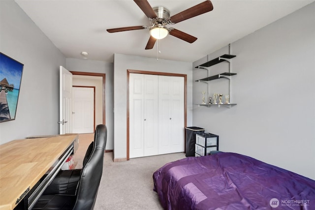 carpeted bedroom featuring a closet, baseboards, and a ceiling fan