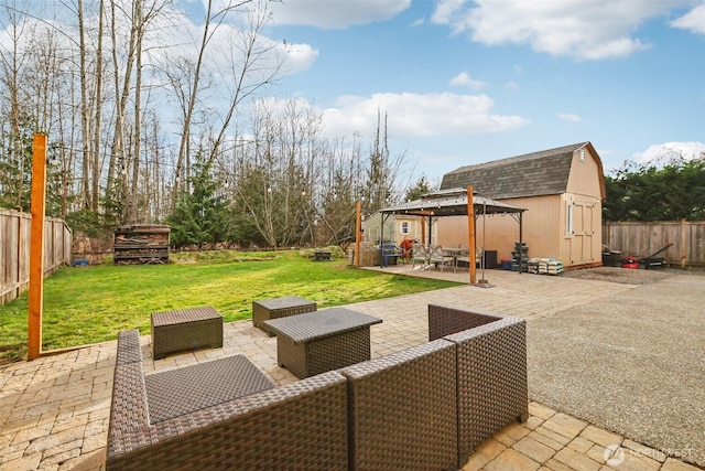 view of patio / terrace featuring a gazebo, an outdoor hangout area, a storage shed, a fenced backyard, and an outdoor structure