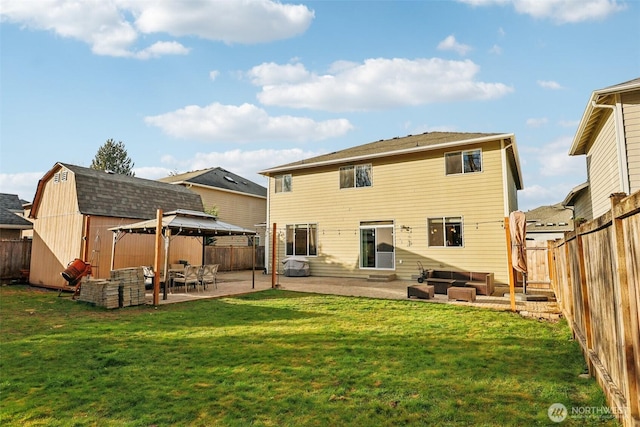 back of house featuring a gazebo, a fenced backyard, an outdoor structure, a patio area, and a storage unit