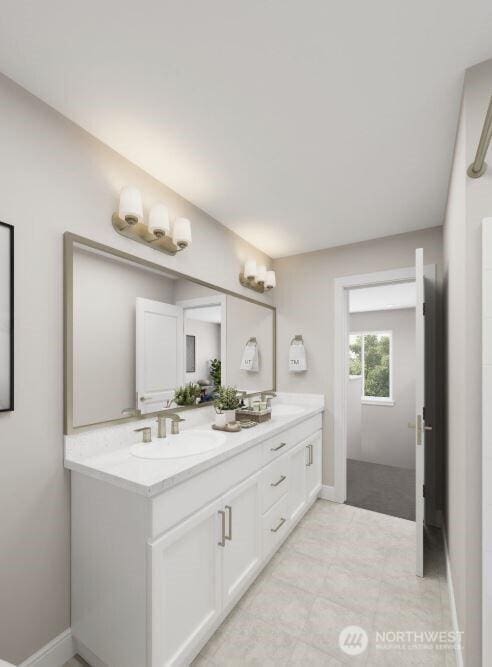 bathroom with double vanity, a sink, and baseboards