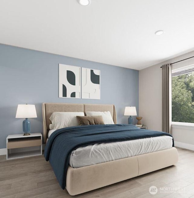 bedroom featuring baseboards and wood finished floors