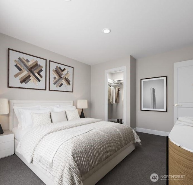 bedroom with recessed lighting, baseboards, a closet, dark carpet, and a walk in closet