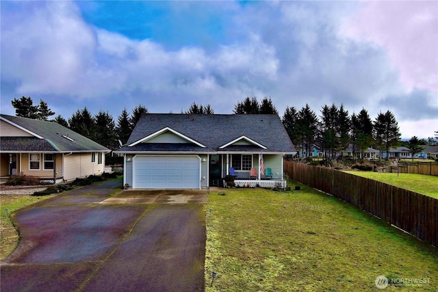 view of front of home featuring a garage, aphalt driveway, a front lawn, and fence