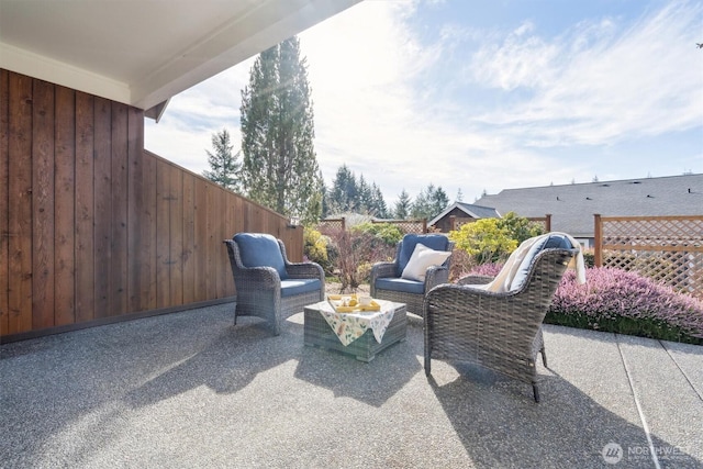 view of patio with outdoor lounge area and fence