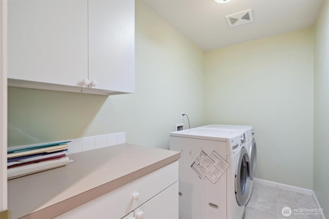 washroom with light tile patterned floors, visible vents, cabinet space, independent washer and dryer, and baseboards