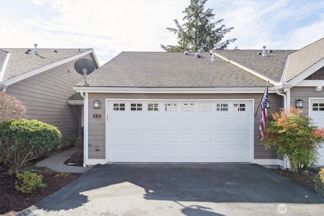 garage with aphalt driveway