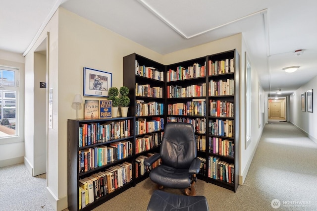 sitting room featuring carpet flooring and baseboards