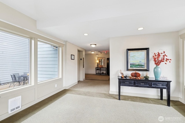 hallway with baseboards, carpet flooring, visible vents, and recessed lighting