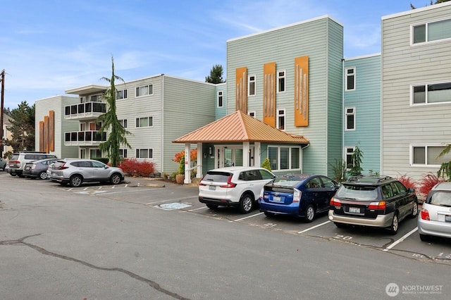 view of building exterior with uncovered parking