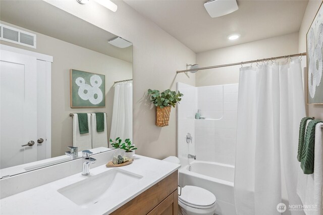 bathroom with toilet, shower / bath combo, visible vents, and vanity