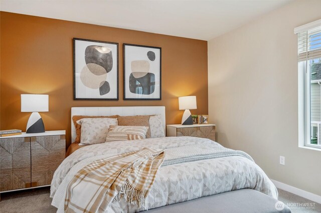 carpeted bedroom featuring baseboards