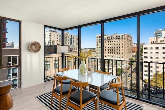 sunroom / solarium featuring a view of city and plenty of natural light