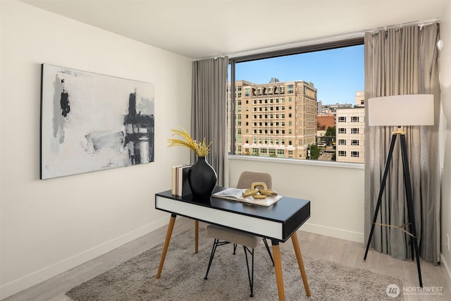 office featuring baseboards and wood finished floors