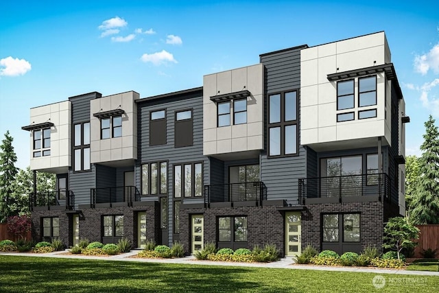 view of front facade with a front lawn and brick siding