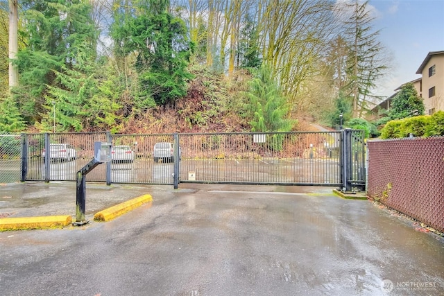 view of gate with fence