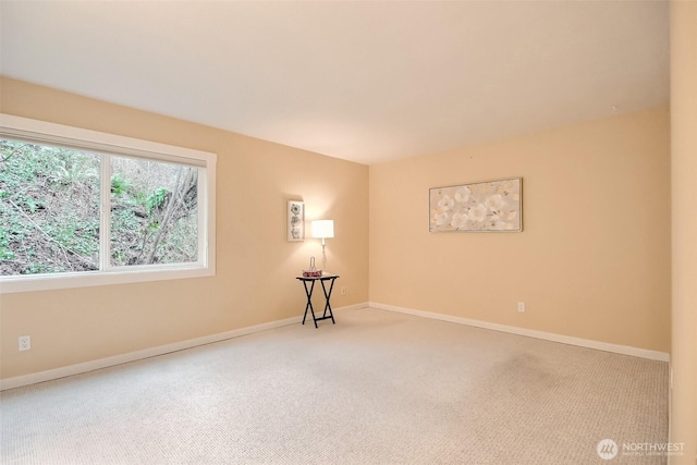 empty room with carpet and baseboards