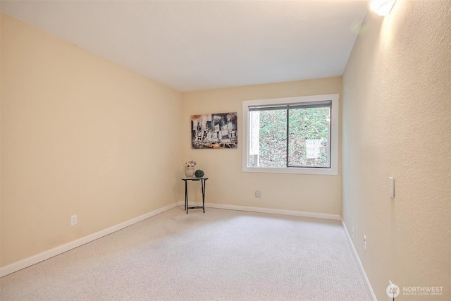 empty room with carpet flooring and baseboards