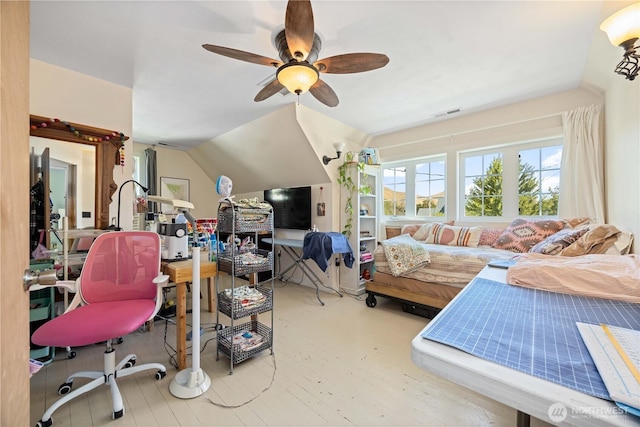 interior space with a ceiling fan, visible vents, and vaulted ceiling