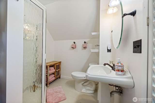 bathroom featuring lofted ceiling, toilet, and baseboards