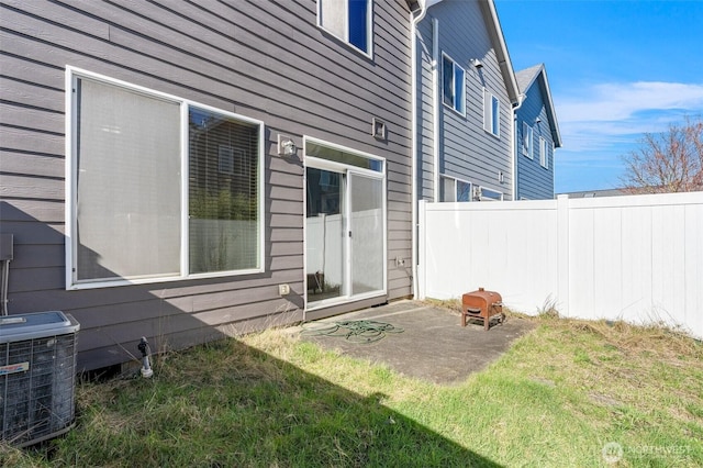 back of house featuring a patio area, fence, a lawn, and central air condition unit