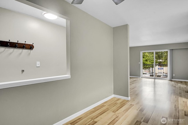 hall with wood finished floors and baseboards