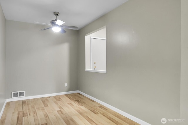 unfurnished room featuring a ceiling fan, visible vents, baseboards, and wood finished floors