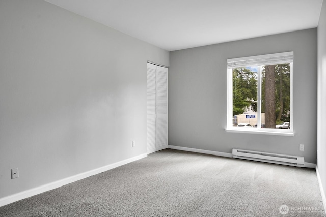 carpeted empty room with baseboards and baseboard heating